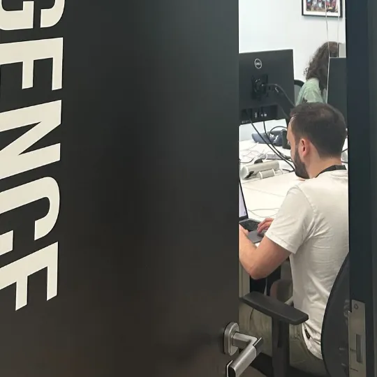 An FXC Intelligence employee through a doorway