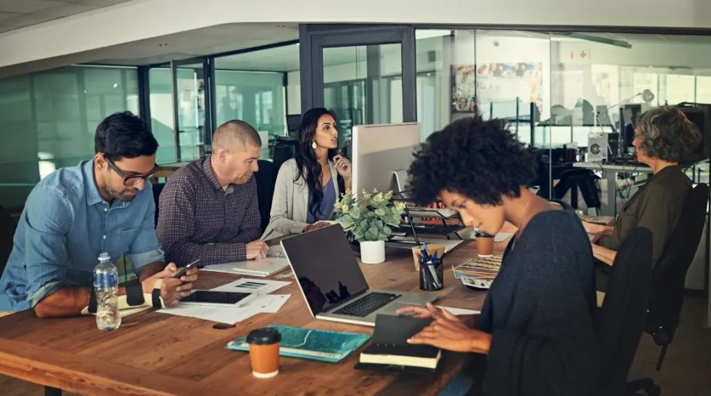 An image showing a group of people working in an office